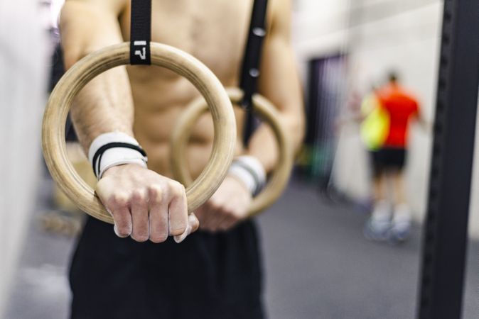 Man training with gymnastic rings in gym
