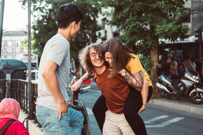 Carefree multiracial friends having fun on street