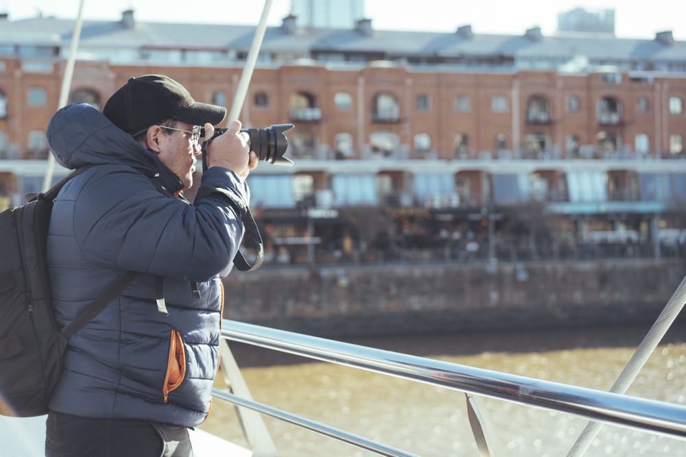 Traveler photographer taking photos at Puerto Madero's canal