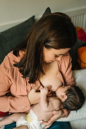 Mom breastfeeding at home