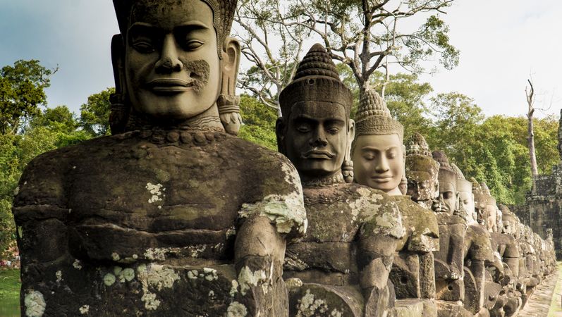Row of ancient temple statues of Buddha
