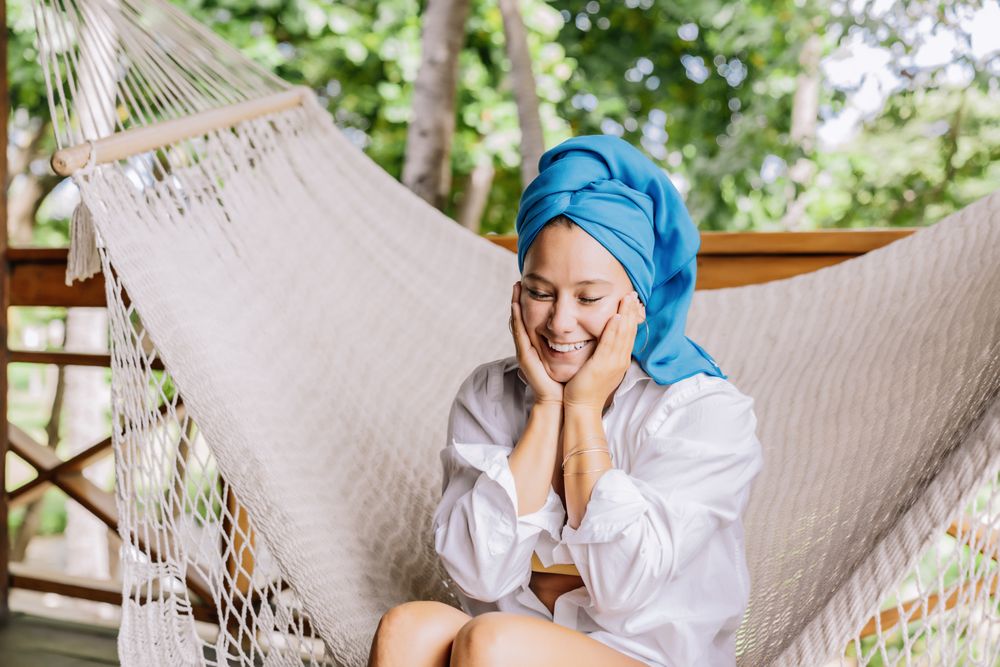 Woman in turban resting in hammock
