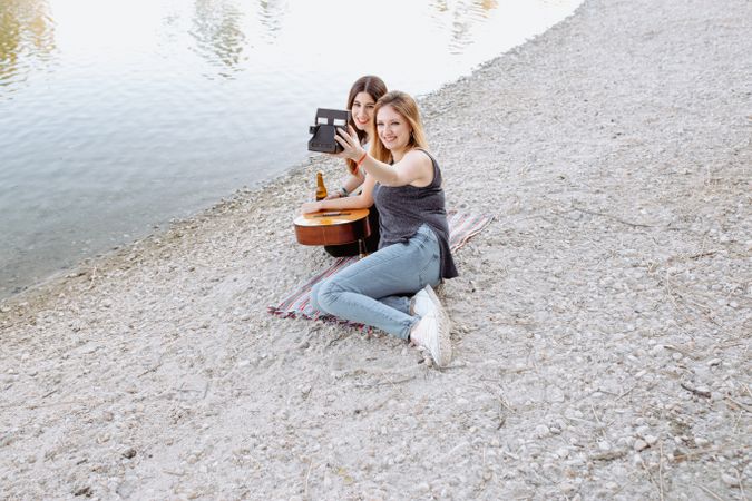Girl friends taking selfie on beach