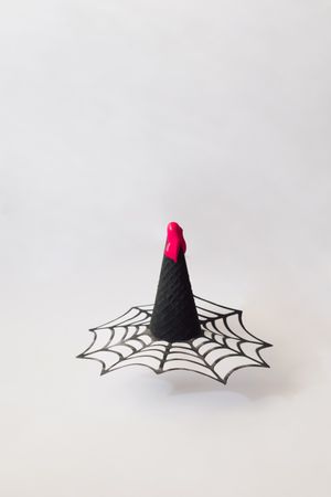 Spiderweb in dark ice cream cone in halloween concept with blood on top