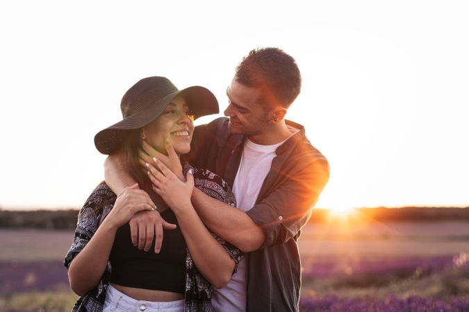 Couple in love in a lavender field at sunset