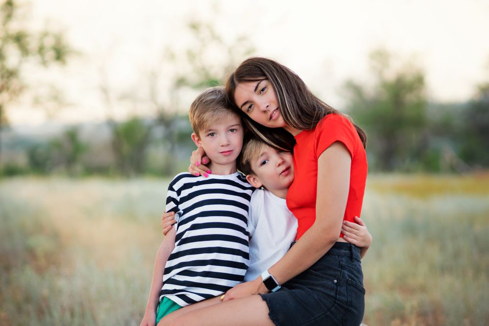 Loving mom with two sons outdoors