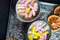 Top view of two marshmallow drinks on grey trey