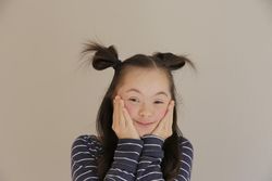 Portrait of female child holding her cheeks with both hands