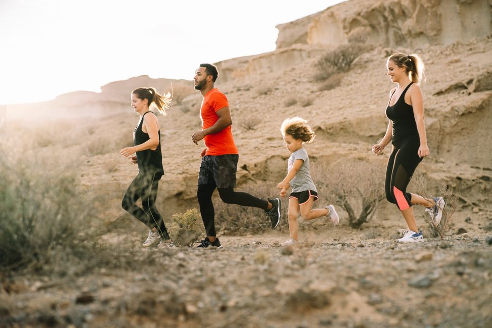 Active diverse family running on nature