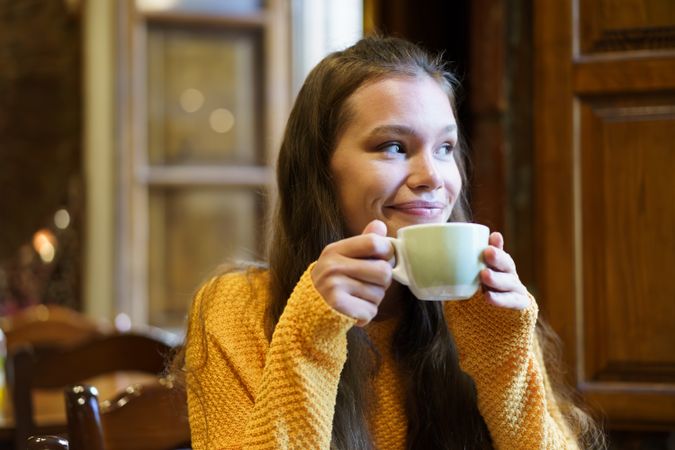 Enjoying a Warm Beverage in a Cozy Caf Setting