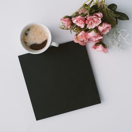 Coffee and dark paper card with flowers