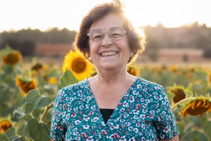 Older woman in a field of sunflowers