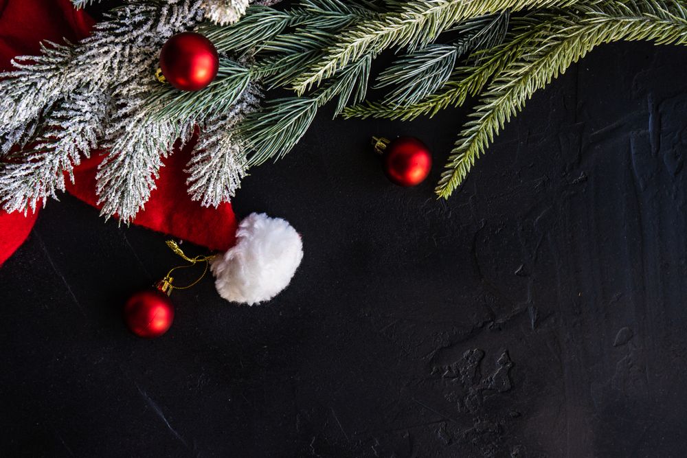 Pine branches with Santa decorations and red baubles