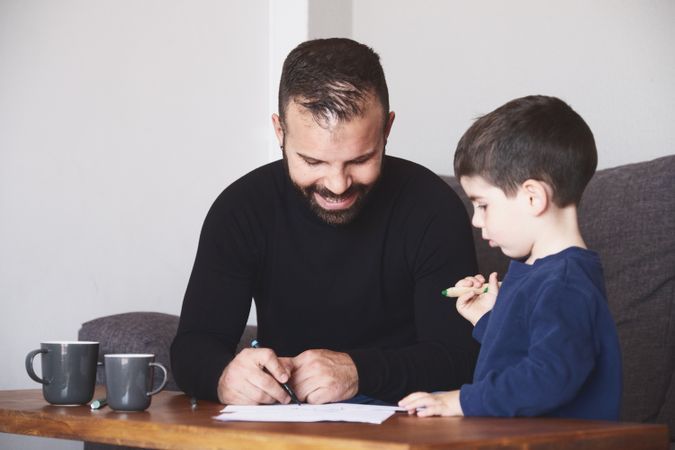 Father and son drawing together