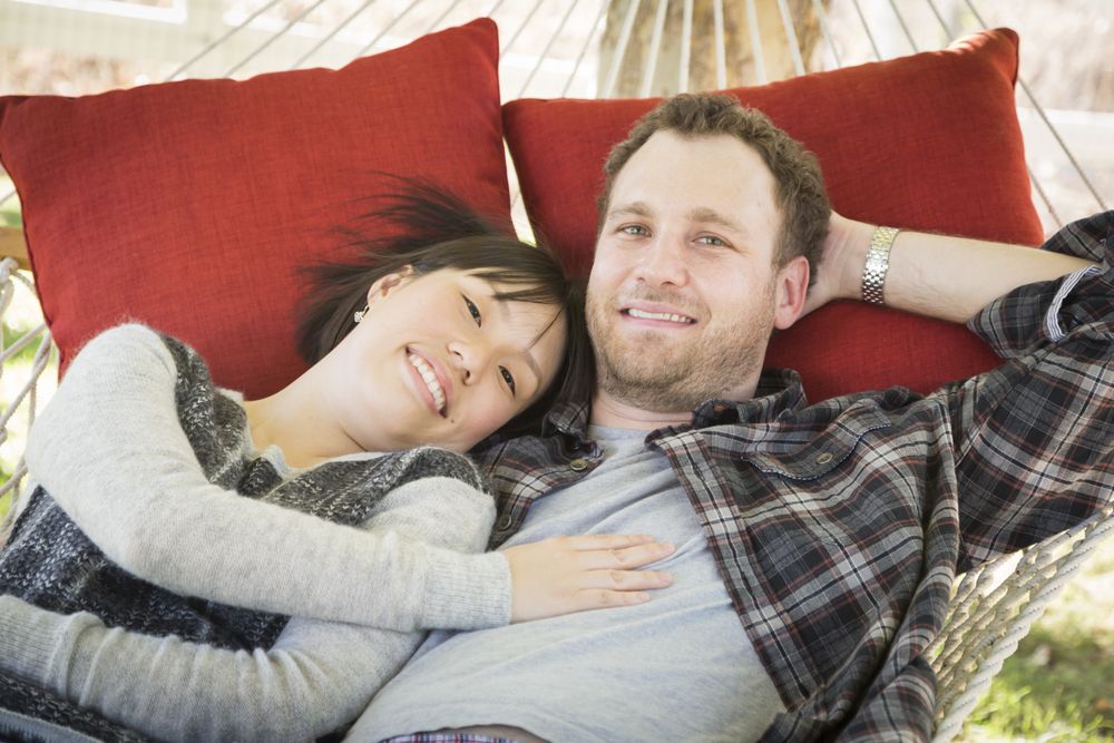 Interracial Couple Relaxing in a Hammock