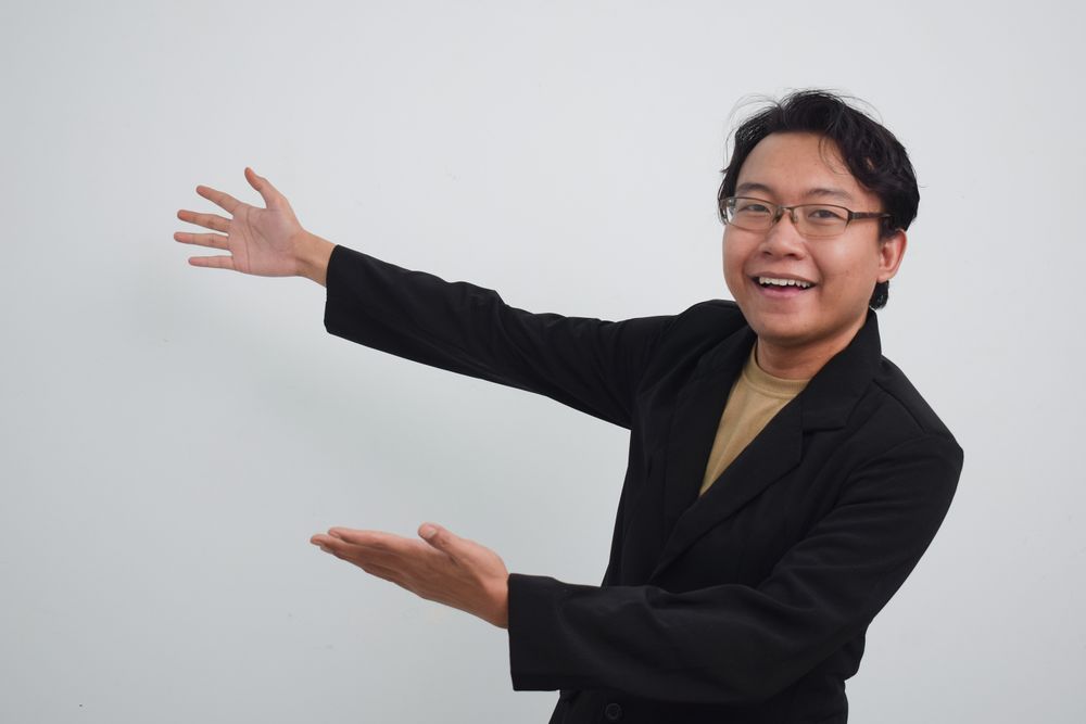 Asian Businessman gesturing to his side