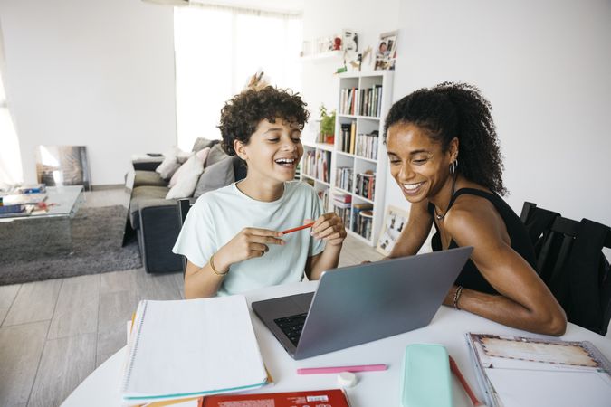 Girl doing her homework with mother