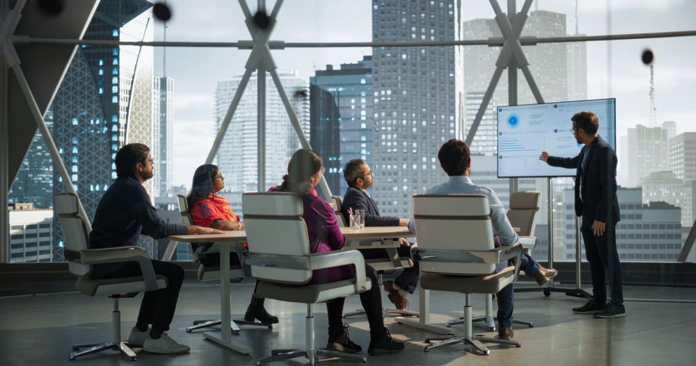 Young Indian Businessman Holds a Presentation for a Diverse Group of Business Partners