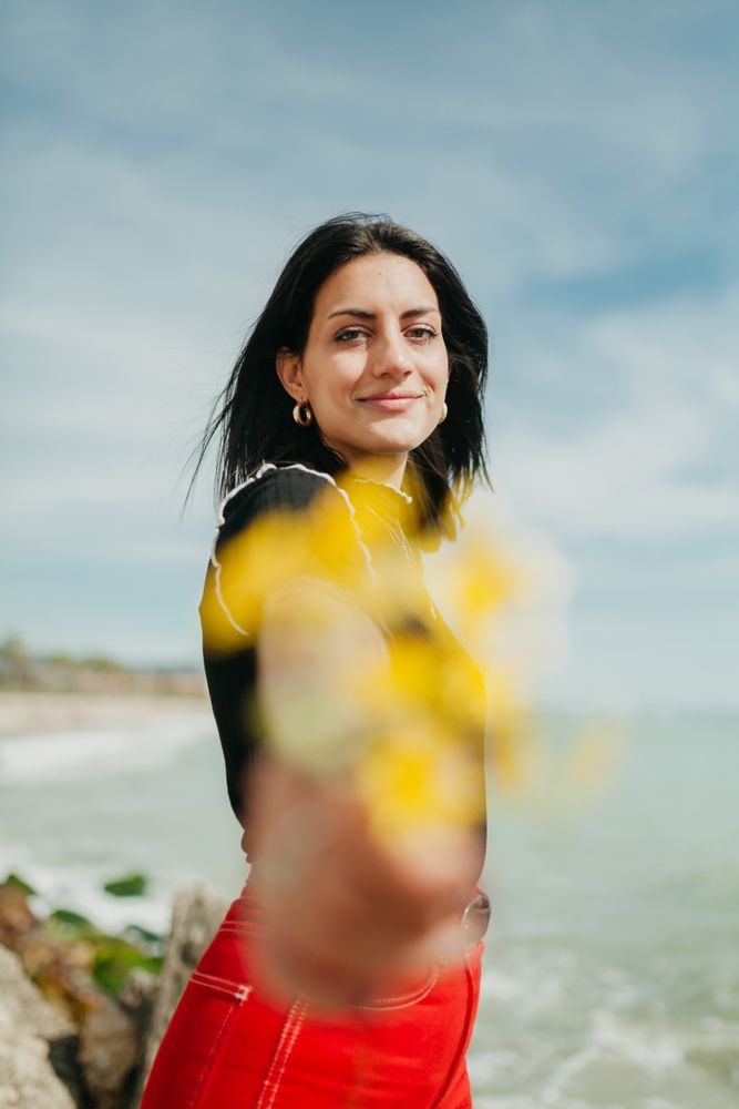 woman giving flowers to camera