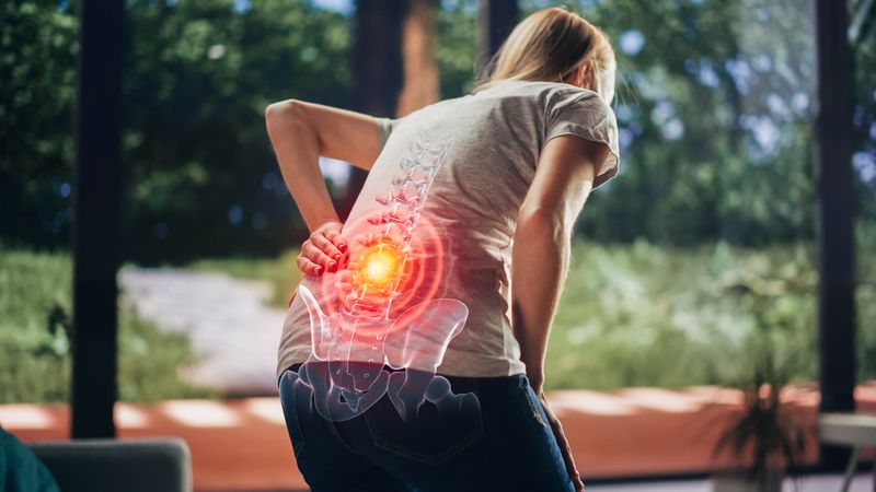 VFX Back Pain Augmented Reality Render. Close Up of a Female Experiencing Discomfort in a Result of Spine Trauma or Arthritis.