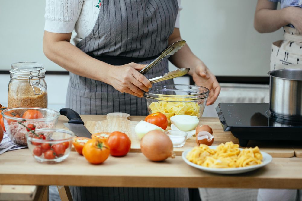 Cropped image of two chef cooking in the kitchen