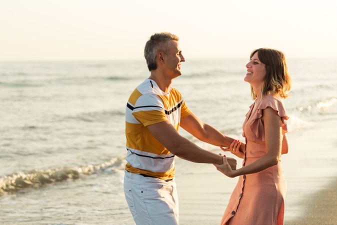 Adult couple dancing near sea