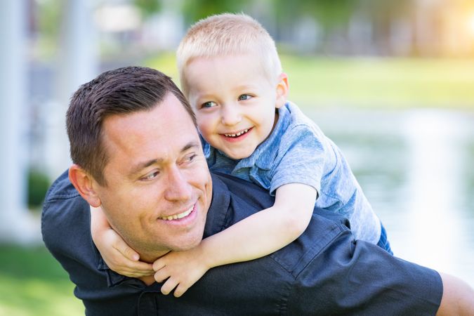 Young White Father and Son Having Fun At The Park