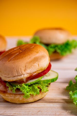 A sandwich with lettuce and tomato on top of a bun