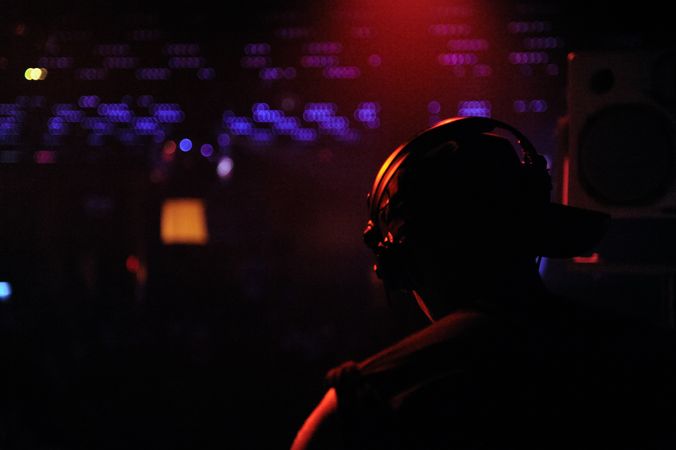 Dark photo of man performing at a club