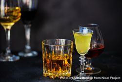 Side view of glasses of different spirits on dark background bDrnQ5