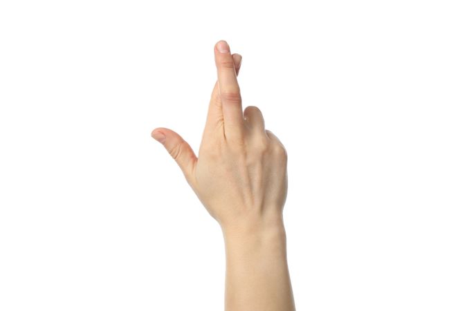 Woman hand with crossed fingers isolated on plain background