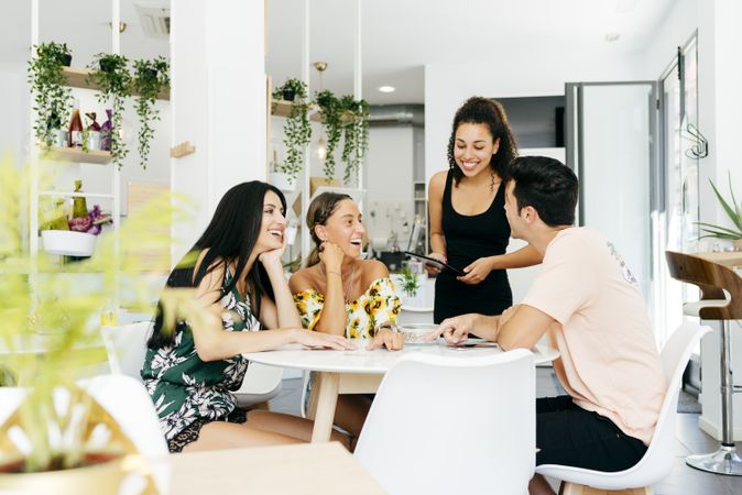 Friends making order in modern cafe