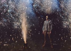 Masked man surrounded by fireworks