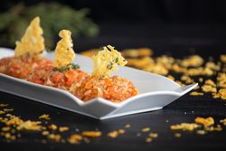 Tasty Quenelles of tomato fondue and Parmensan tile in ornamental plate