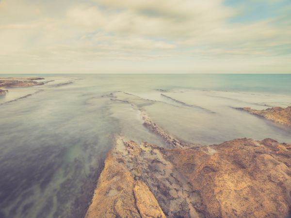 Rocky seashore under blue sky