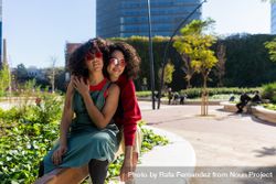 Two female friends having fun in city park together 49JQLb