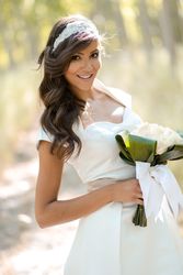Woman in wedding dress and bouquet in forest