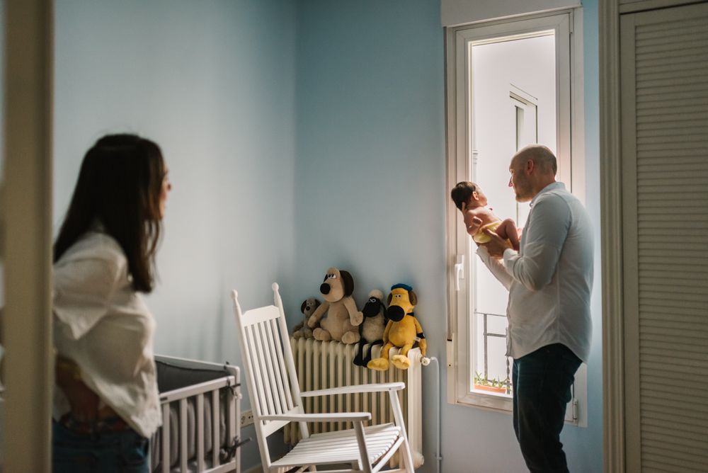 Parents talking to baby in nursery