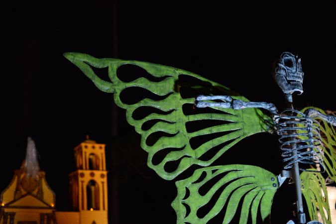 Large art piece of skeleton with wings at Dia de Los Muertos
