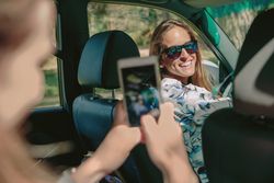 Happy woman looking to her friend for a photo