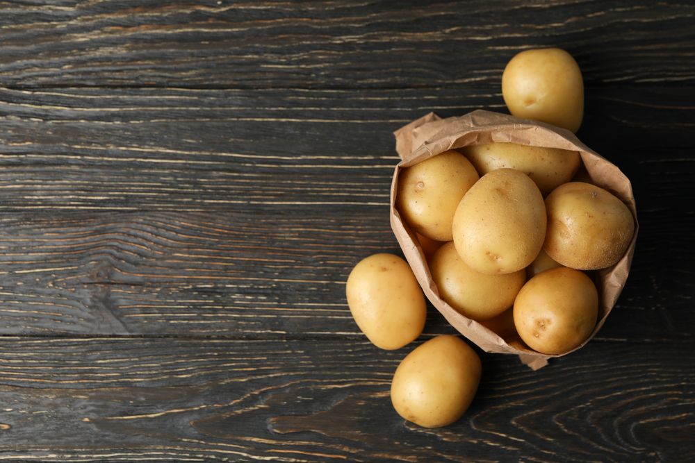 Top view of potatoes in paper, copy space