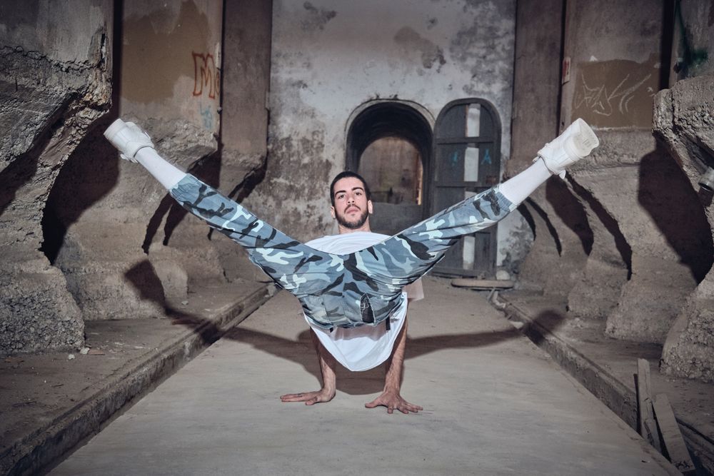 Man dancing break dance in abandoned building