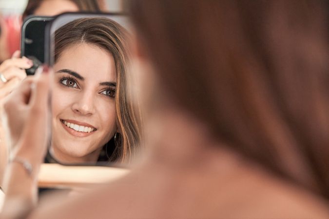 Content woman looking at mirror
