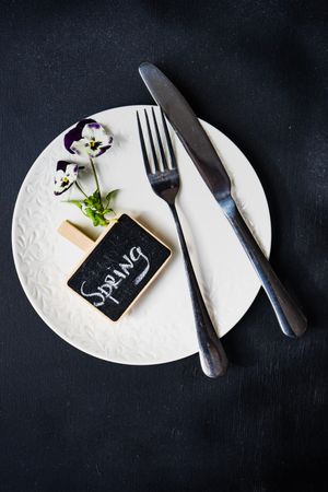 Top view of spring table setting with delicate purple flowers