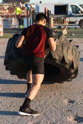 Strong man doing tire flip exercise