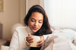 Enjoying Morning at Home: Young Woman Drinking Coffee