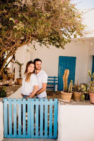Loving couple cuddling near beach house