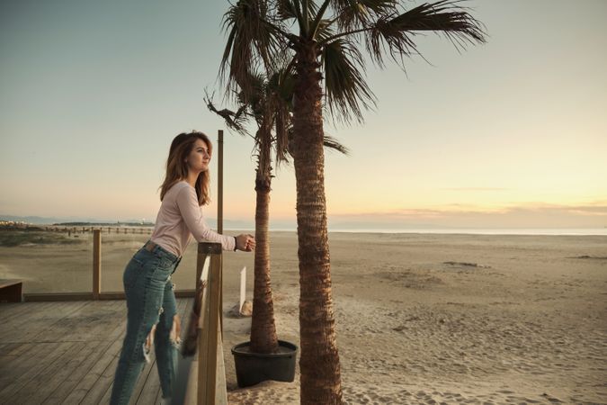 Woman on beach enjoying sunset