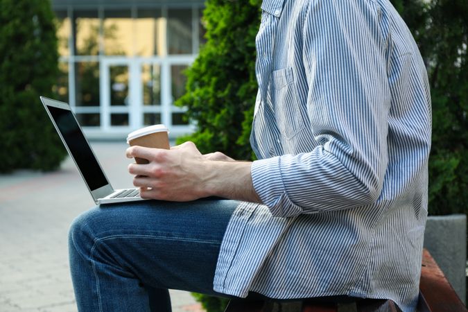 Young student working in a laptop and drinking coffee. Study. University