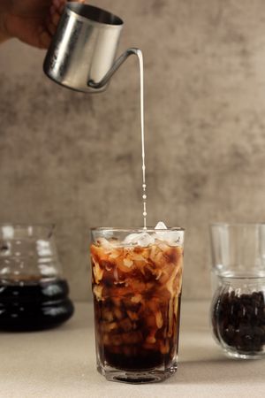 Pour Espresso to the Milk in the Glass Making Iced Coffee Latte